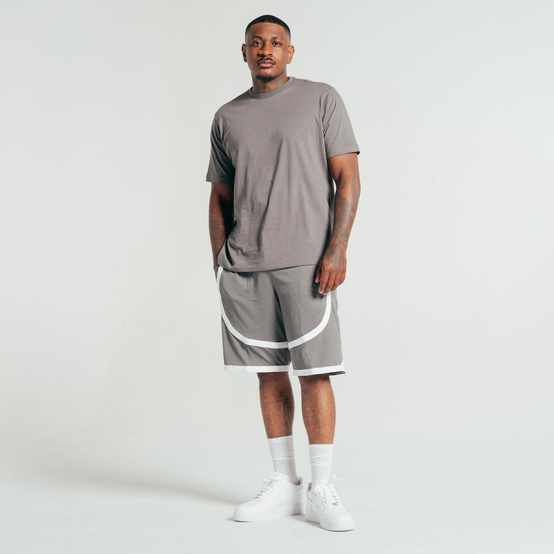 Men's gray athletic shorts with white contrast tape at hem, elastic waistband