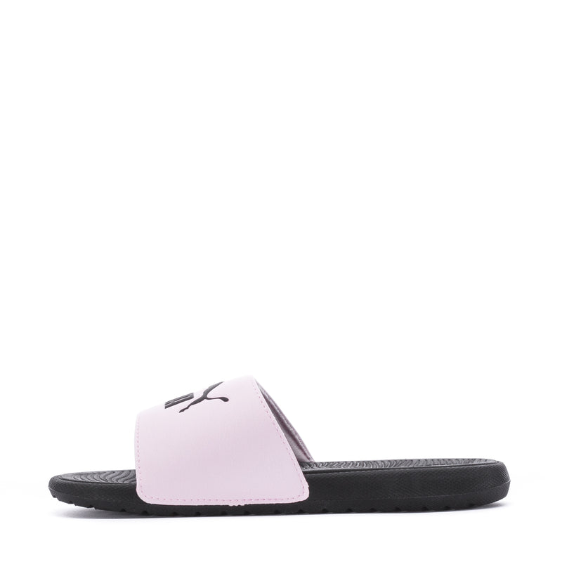 Youth pink slide sandals with black footbed and PUMA mark on strap.