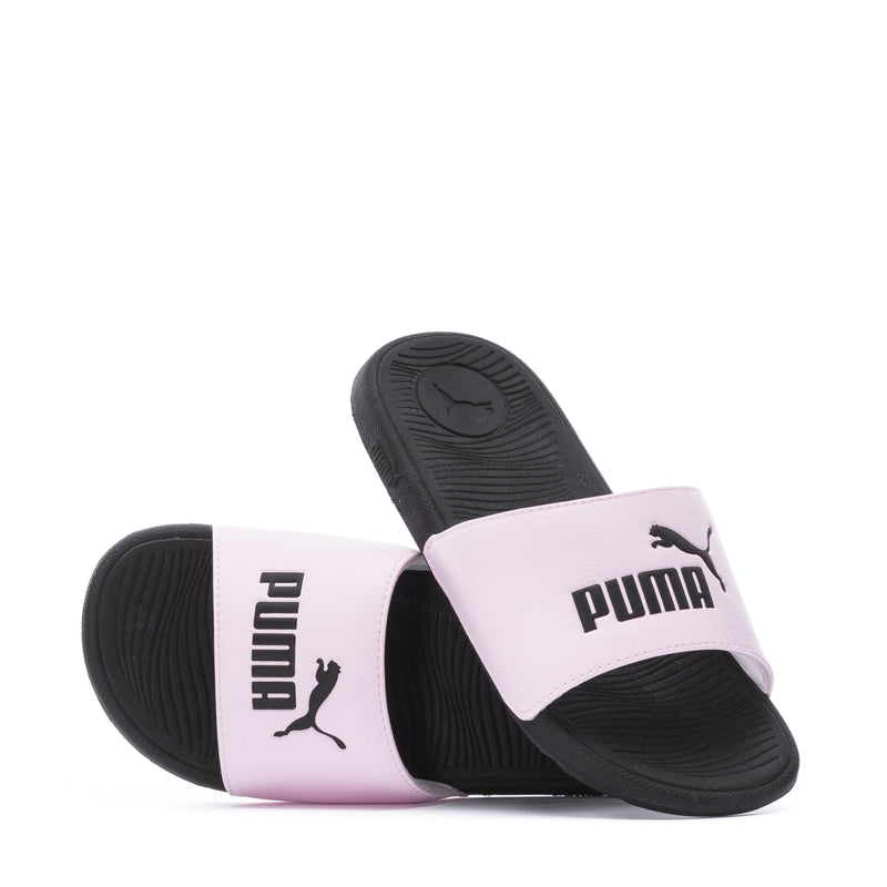Youth pink and black slide sandals showing PUMA logos on two straps.