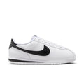 White and black men's low-top sneakers, side profile with Nike swoosh and laces
