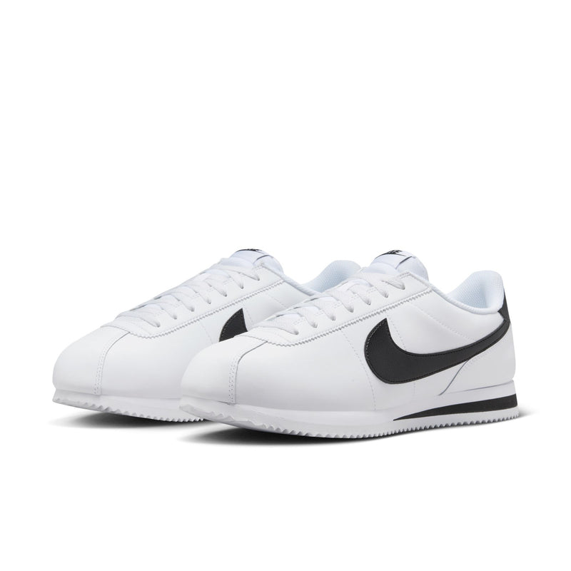 Pair of white men's low-top sneakers with black Nike swooshes and lace-up closure