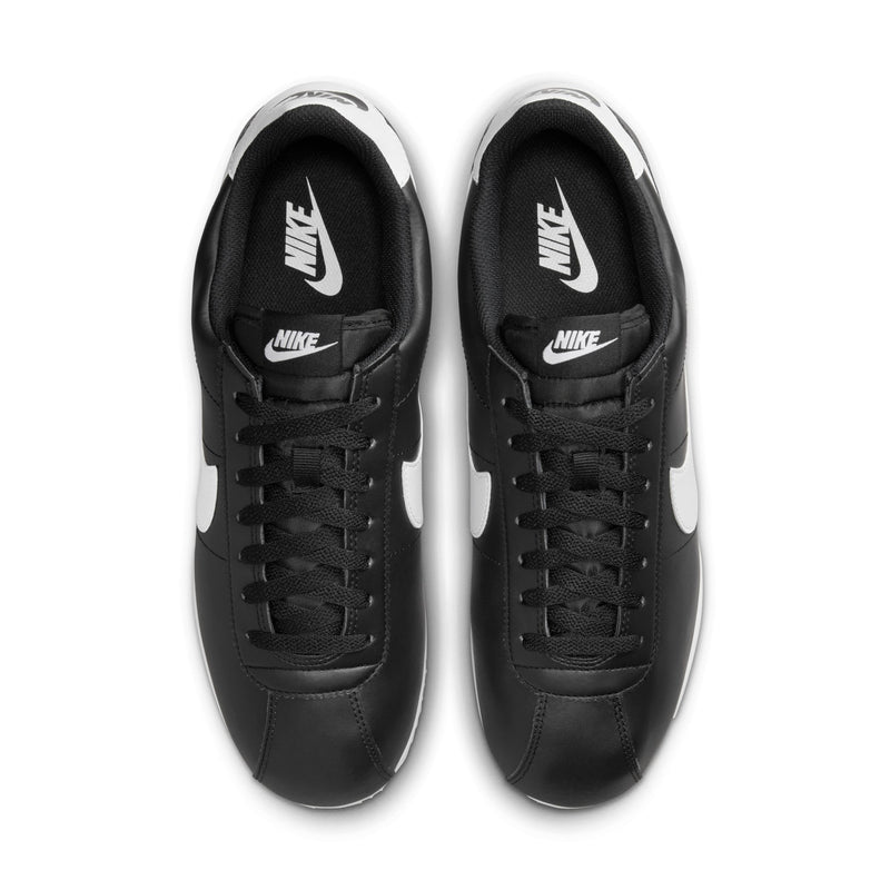 Men's black Nike Cortez sneakers with lace-up front and white tongue lining
