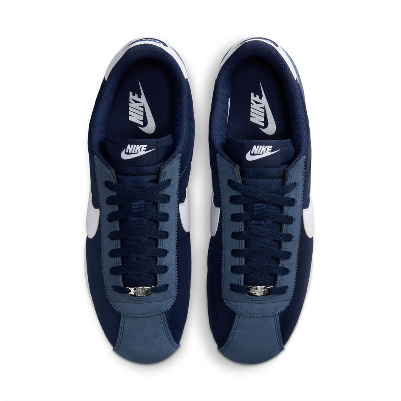 Men's navy Cortez sneakers, top view; laces and tongue with Nike branding