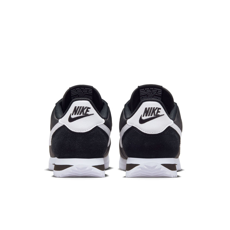 Rear view of black sneakers with white Swoosh and heel Nike branding