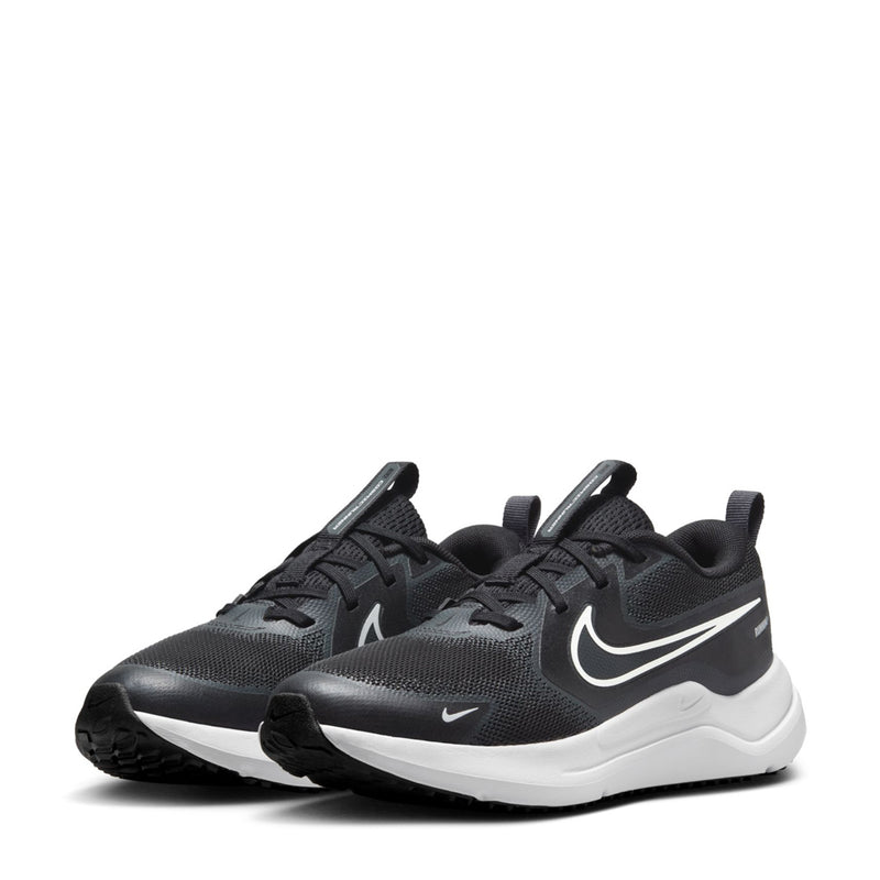 Pair of youth black running shoes with white swoosh accents and chunky white sole