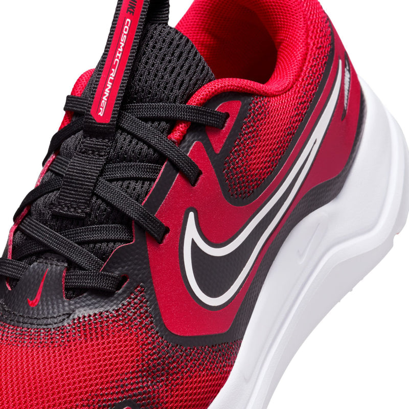 Youth running shoe close-up, red knit upper with black laces and white swoosh