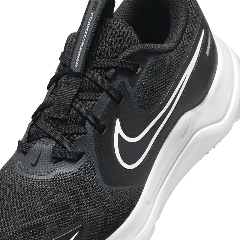 Close-up youth black mesh upper with white swoosh, lace-up, and side support panel