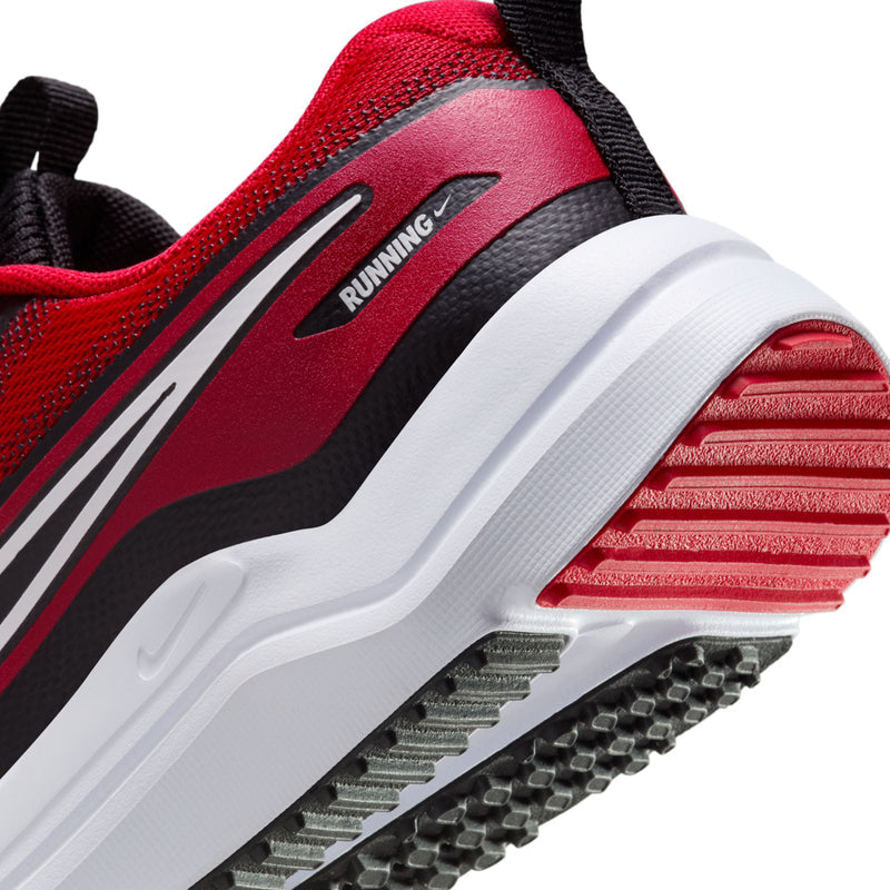 Youth running shoe close-up, red upper with black stripe and white tread sole