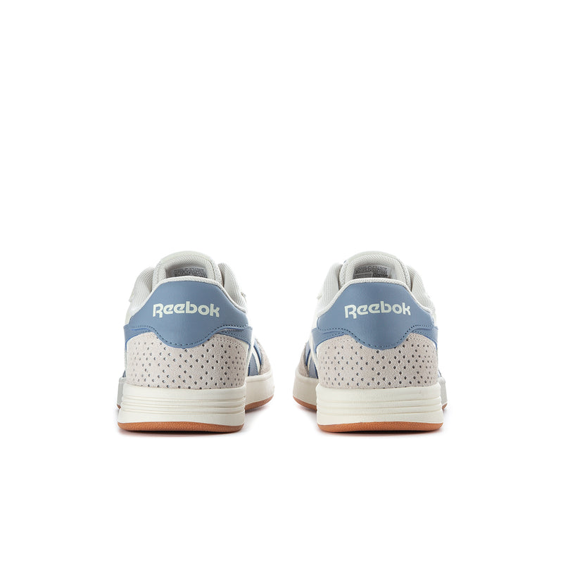 Men's Reebok court sneakers heel view, white with blue heel tab and gum outsole