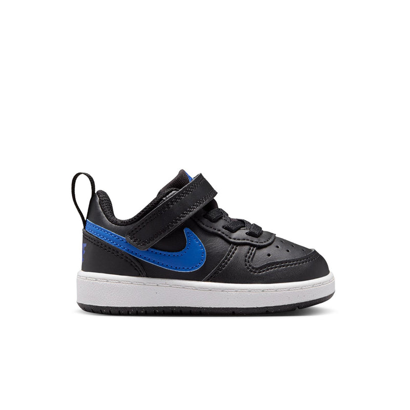 Kids' black low-top sneakers with blue swoosh, white midsole, velcro strap