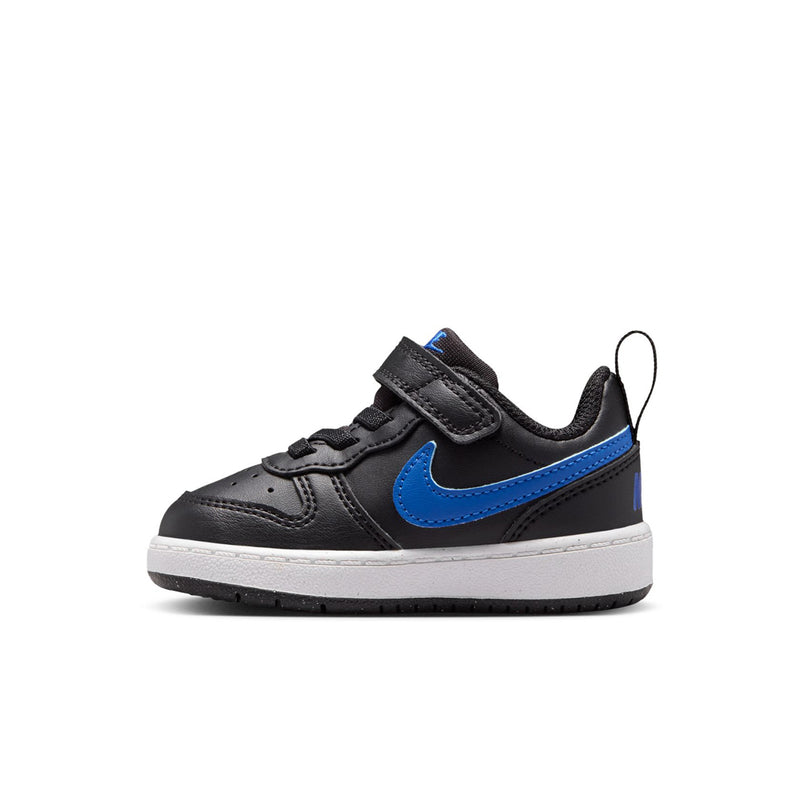 Kids' black low-top sneakers with blue swoosh and white midsole detail, velcro strap