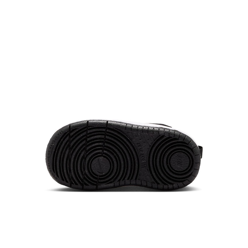 Kids' black sneaker outsole with circular tread pattern, low-top style