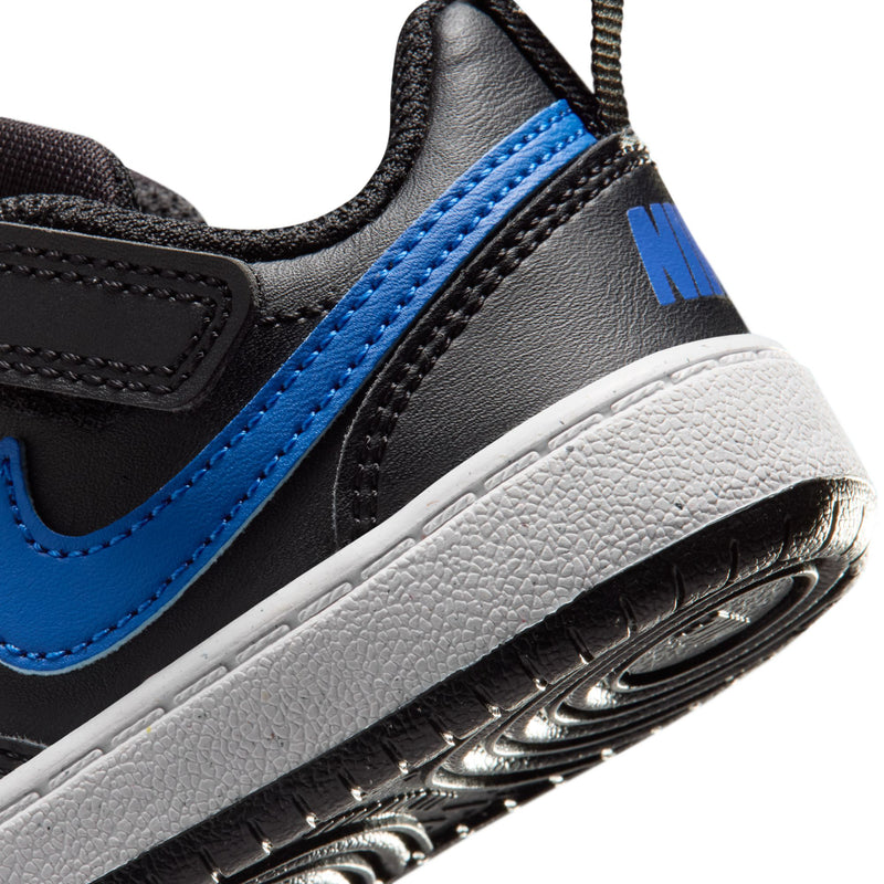 Kids' black sneaker side close-up with blue stripe and white midsole, air unit window