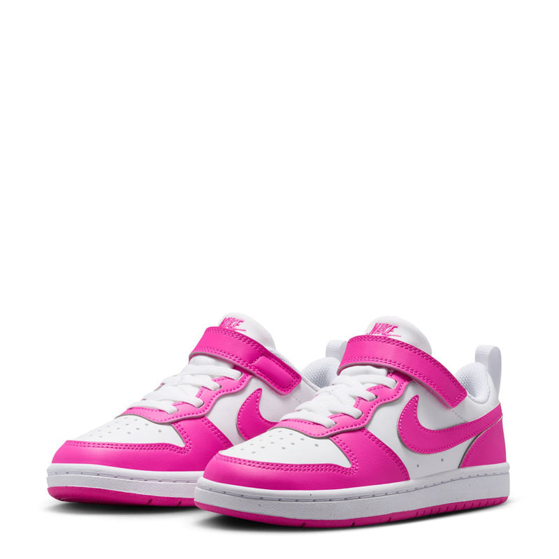 Pair of kids low-top sneakers in white and fuchsia with perforated toe and swoosh details.