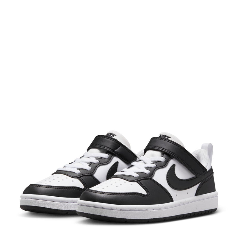 Pair of kids low-top sneakers, white and black with Nike swoosh and hook strap