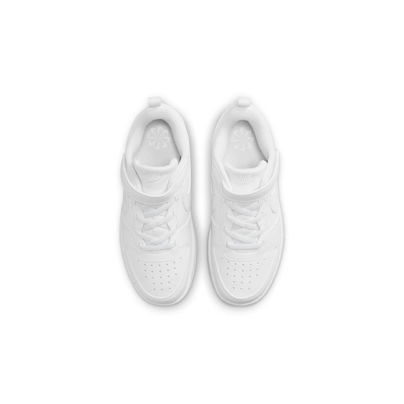 White kids sneakers, top view showing laces and perforated toe