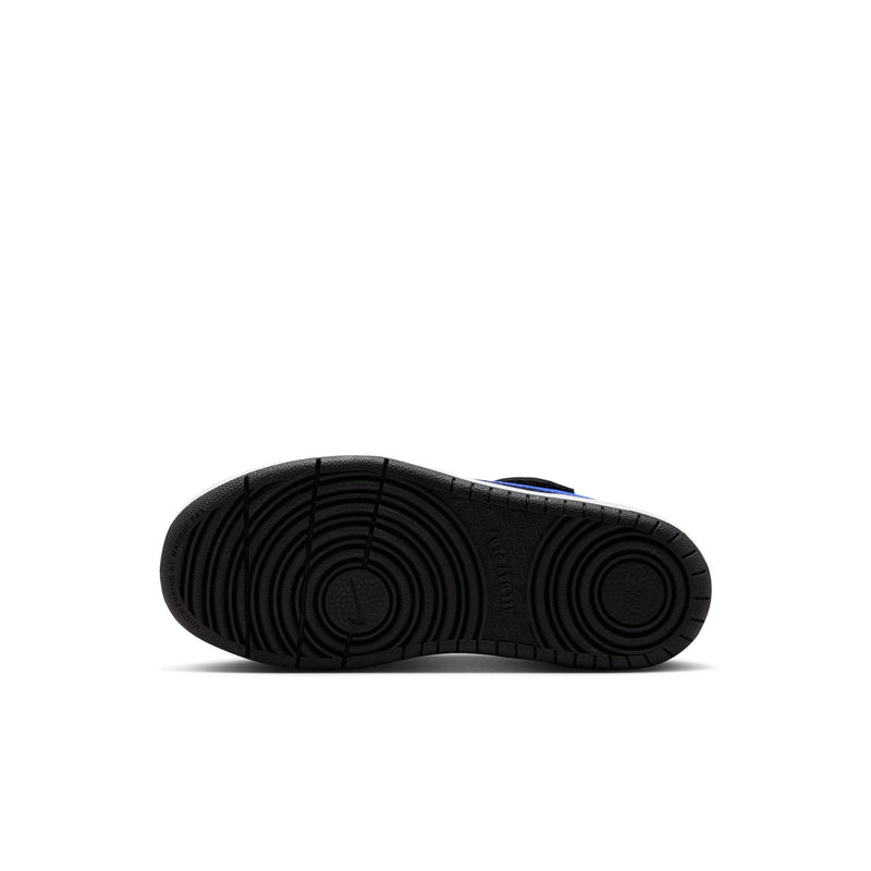 Kids sneaker outsole, black rubber tread with blue trim near heel