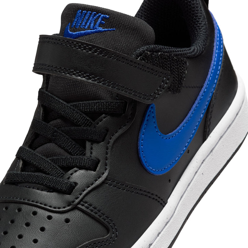 Kids sneaker upper close-up, black strap and laces with blue Swoosh detail