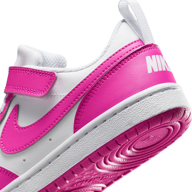 Kids sneaker close-up: white and fuchsia side panel with NIKE branding and grippy sole.