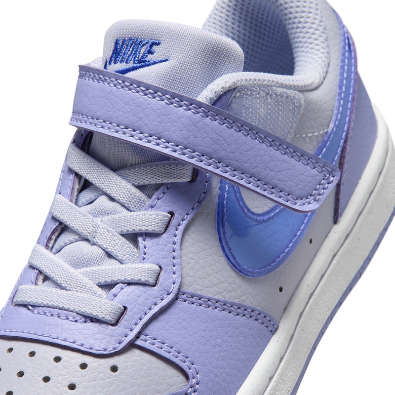 Kids sneaker close-up: light purple padded collar, blue swoosh, velcro strap