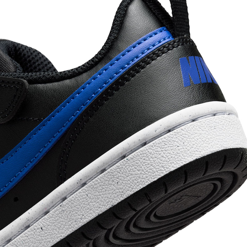 Kids sneaker side close-up, black upper with blue stripe and white textured sole