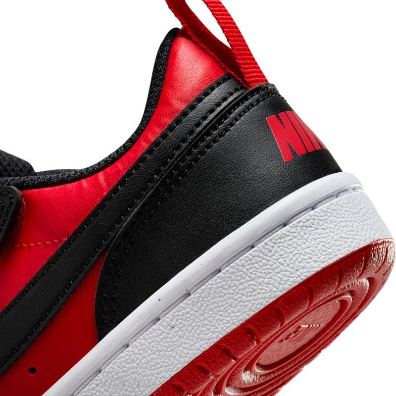 Kids sneaker side close-up with red and black leather, white midsole, Nike logo