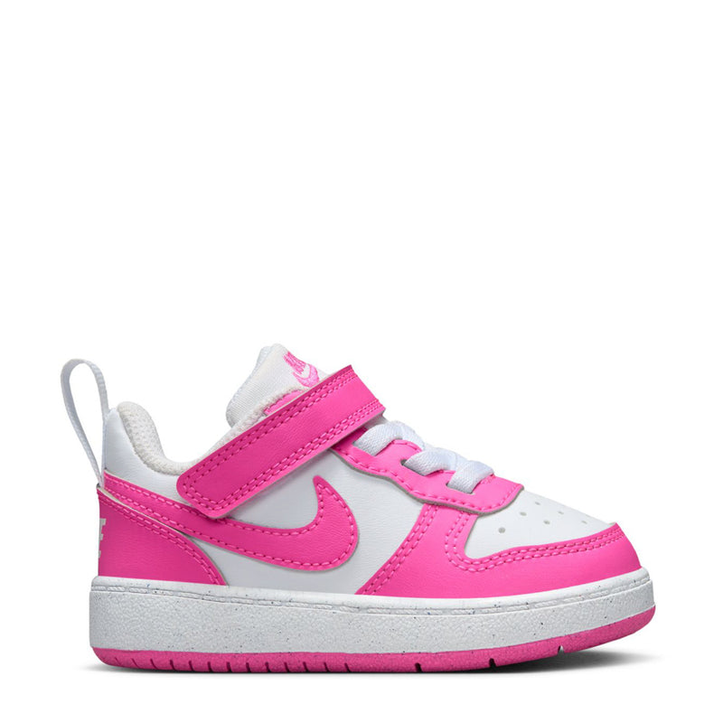 Toddler low-top sneaker in white and fuchsia with hook-and-loop straps and Nike swoosh.