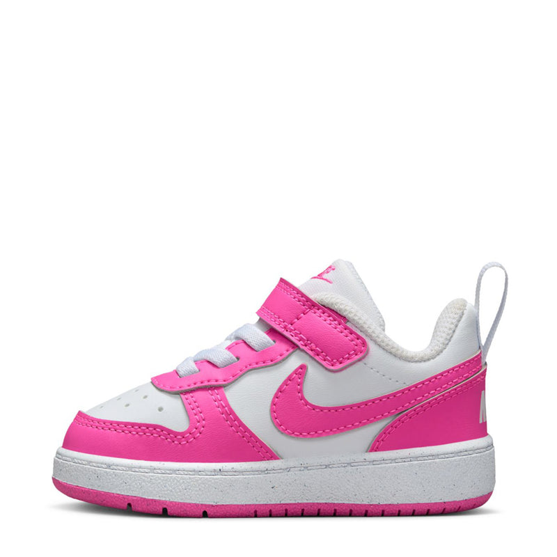 Toddler low-top sneaker side view in white with fuchsia panels, Velcro strap, Nike swoosh.