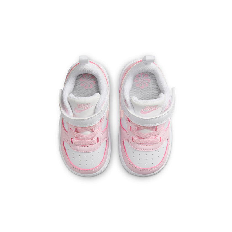 Toddler sneakers front view: white upper with pink laces, stitching, and padded tongue.