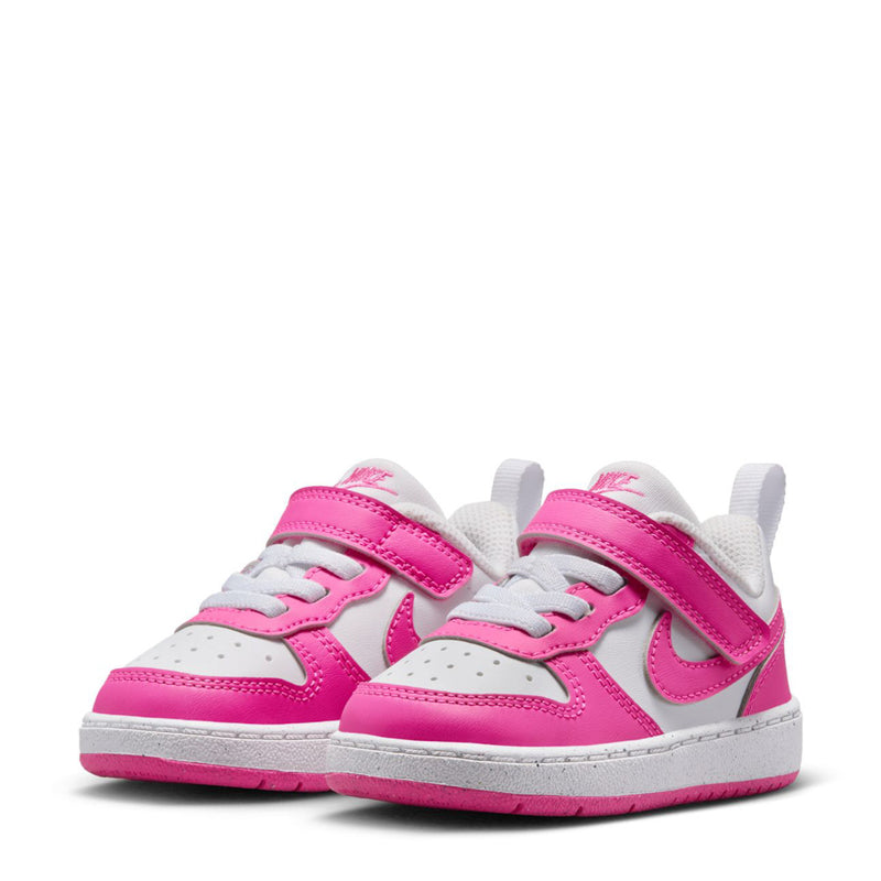 Toddler low-top sneaker pair with white uppers and bright fuchsia Velcro straps, Nike logo.