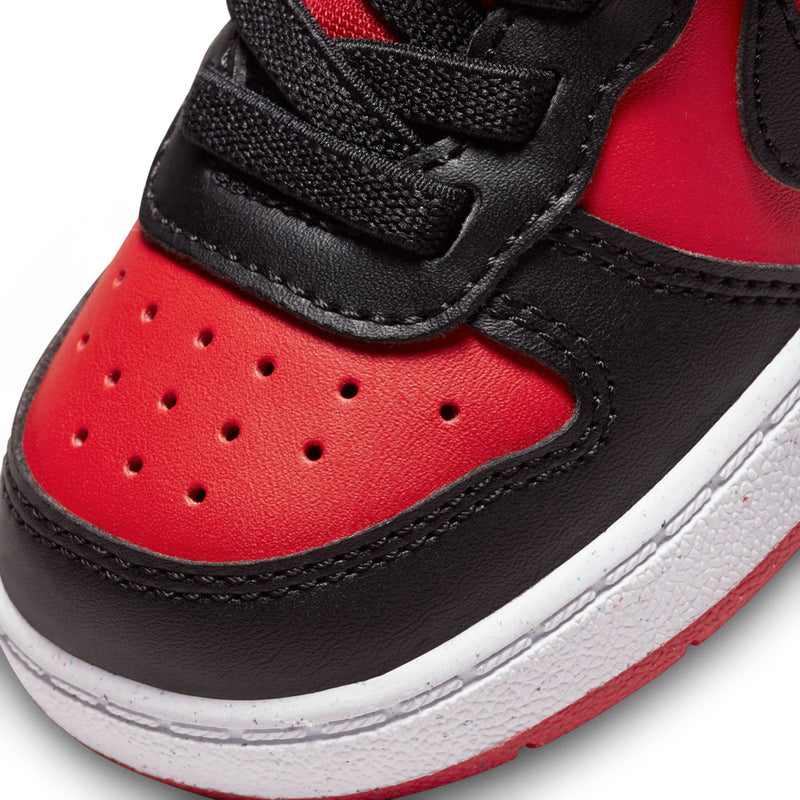 Close-up of toddler red and black sneaker with perforated toe and padded strap