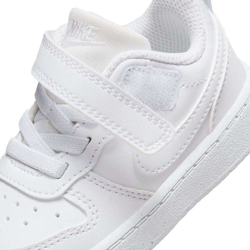 Toddler white sneaker detail showing hook-and-loop strap and textured midsole