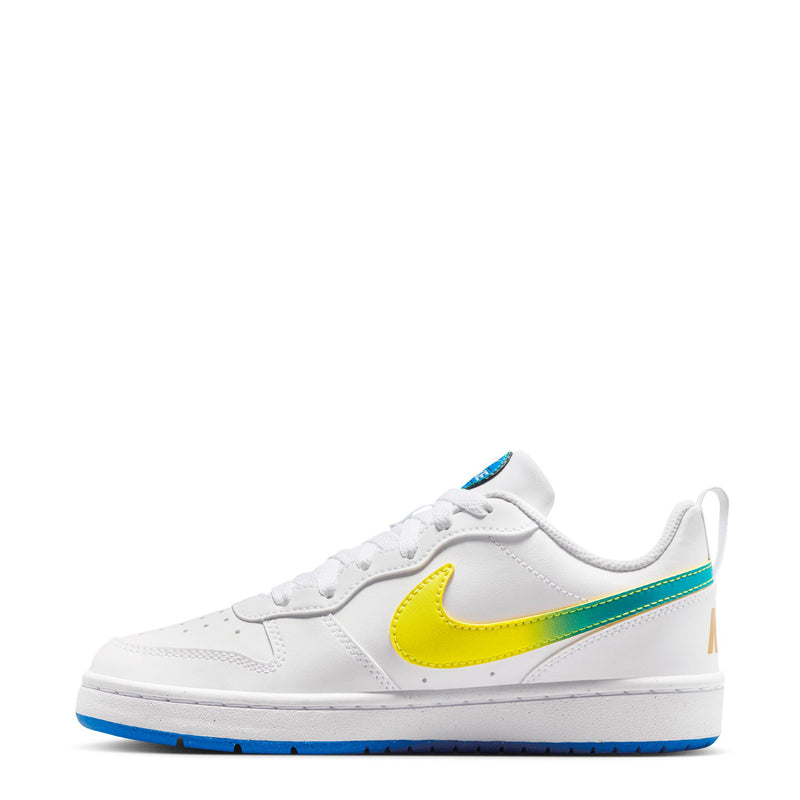 Youth low-top sneakers in white with yellow swoosh, green stripe, and blue bottom
