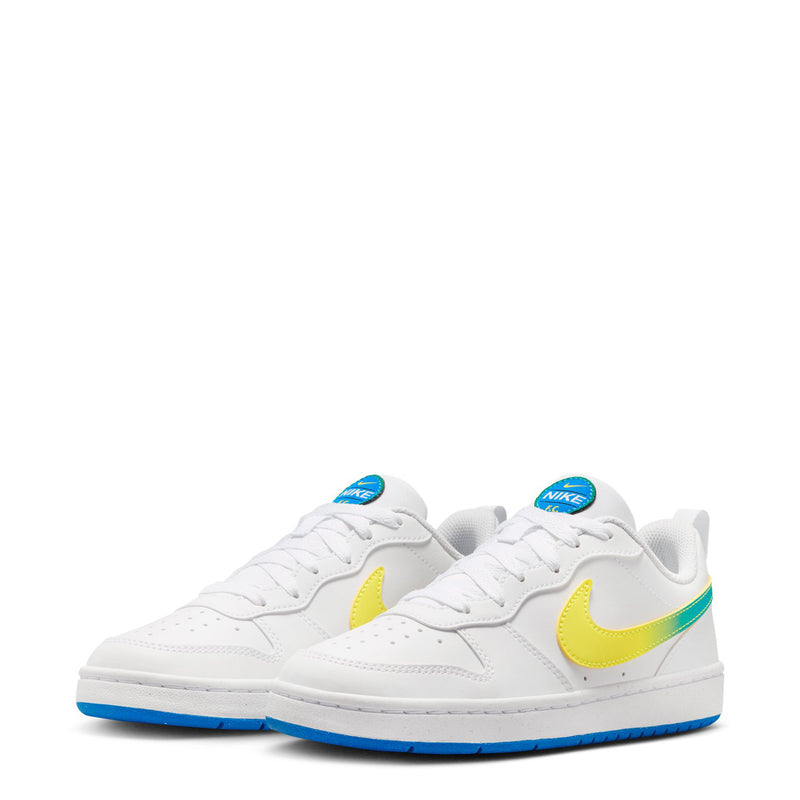 Pair of youth low-top sneakers, white uppers with yellow swoosh, green stripe, blue sole