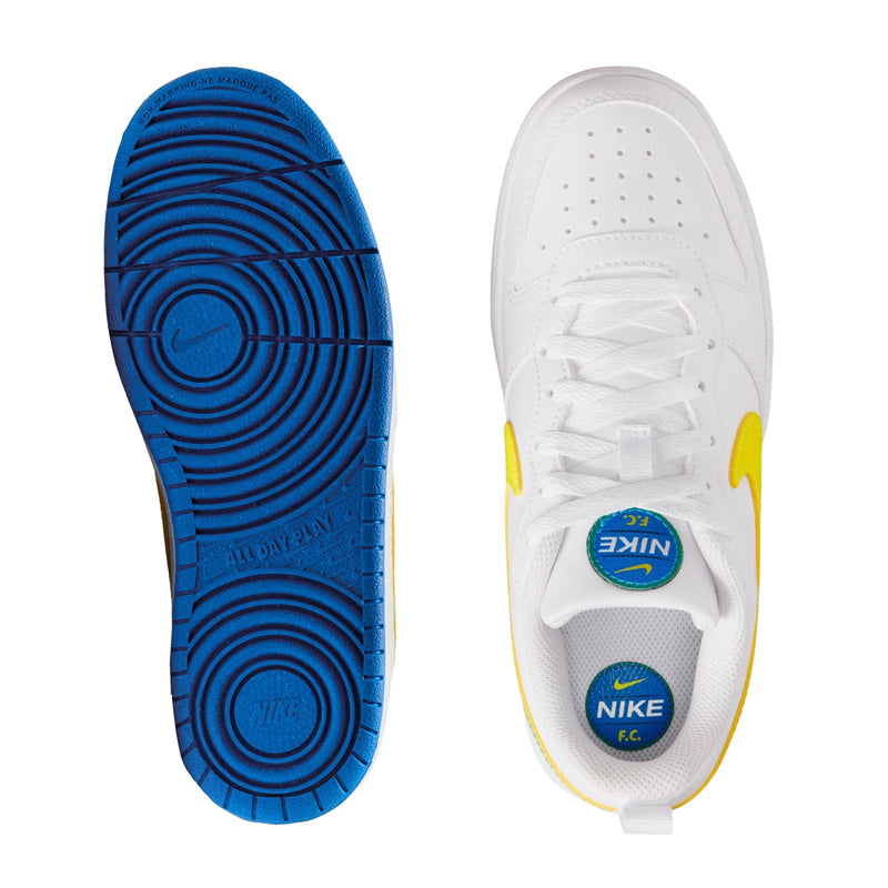 Shoe outsoles: one blue tread sole and one white sole with Nike F.C. branding