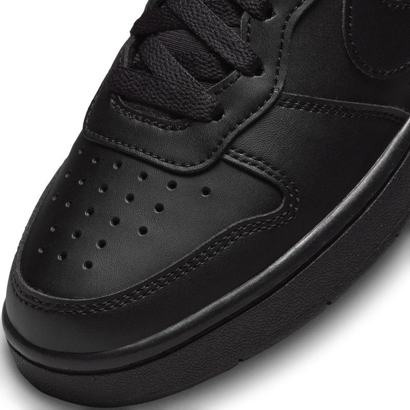 Black youth sneaker toe box with perforations, stitched panels, and lace-up closure.