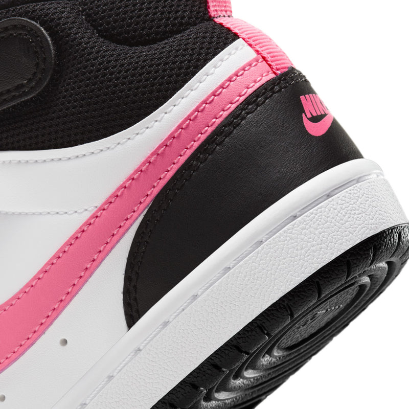 Kids sneaker close-up: pink swoosh stripe over black and white leather