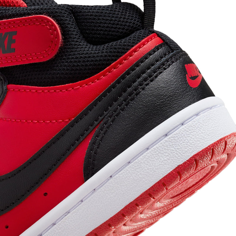 Kids sneakers detail, red and black upper with Nike branding and textured sole edge