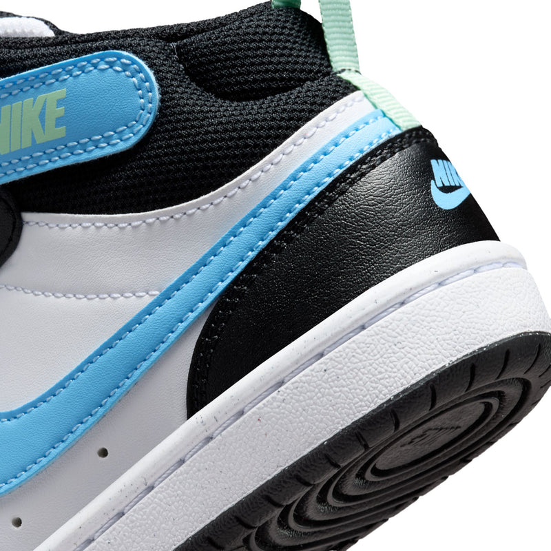 Close-up kids sneaker side with light blue strap, white sole edge, Nike patch