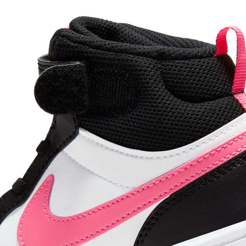 Kids sneaker close-up: black mesh collar, white leather, pink swoosh and laces