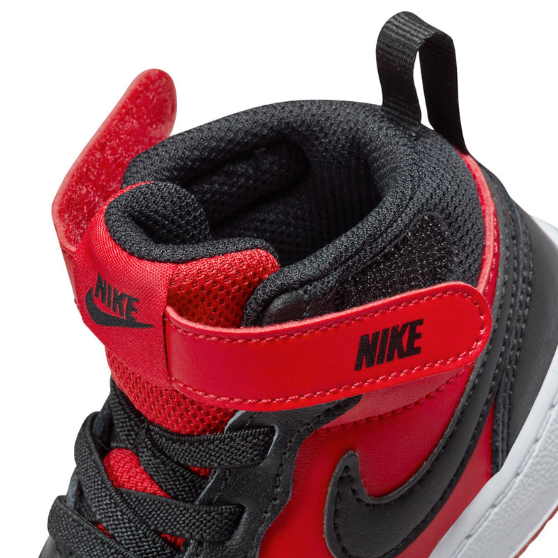 Toddler sneaker close-up of Nike heel and strap, red lining with black laces