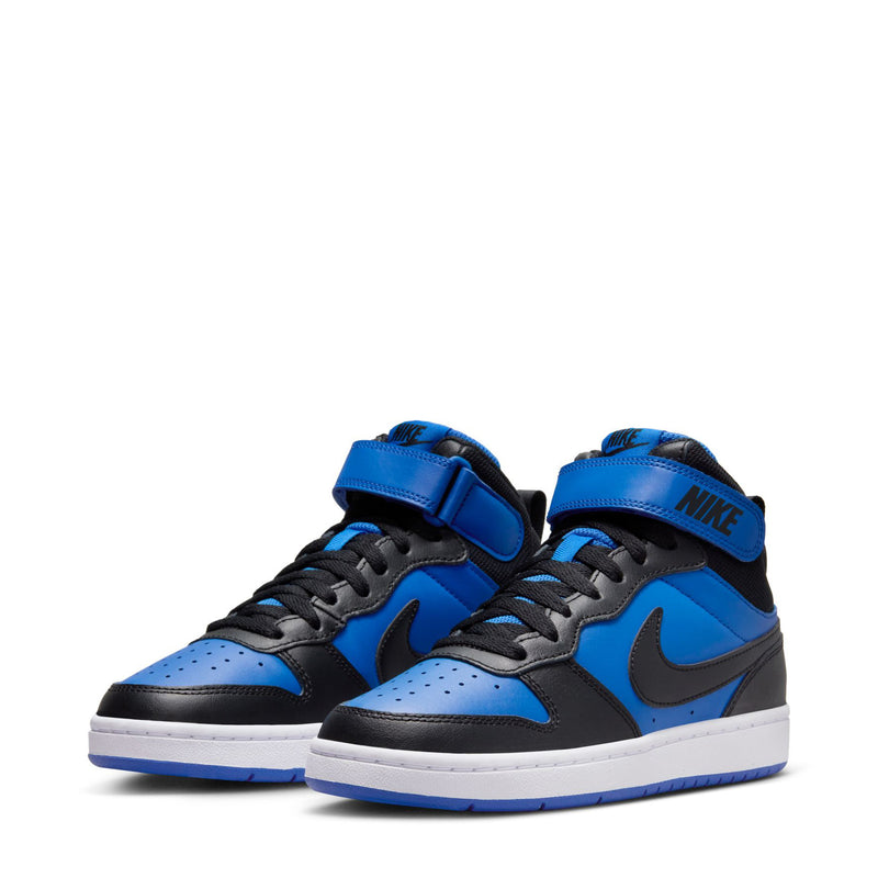 Pair of mid-top youth sneakers in royal blue and black with white soles