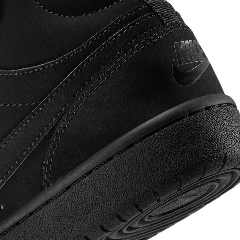 Black youth sneaker side close-up with Nike Swoosh and textured rubber midsole
