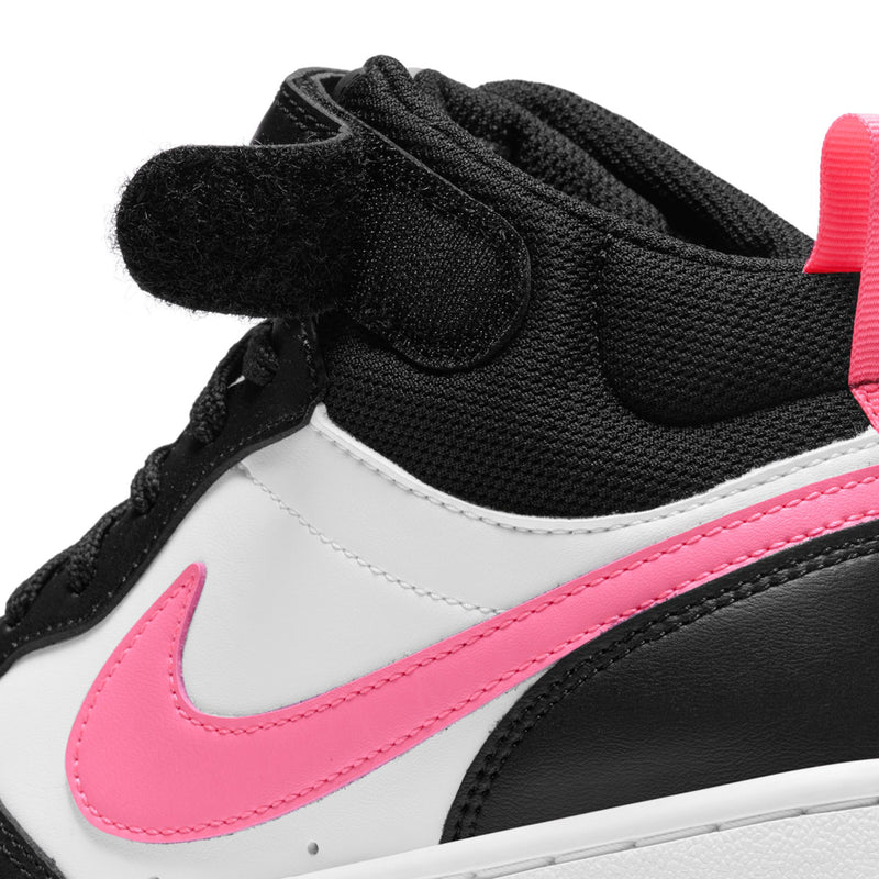 Youth sneaker upper close-up in black and white with pink Nike swoosh and laces
