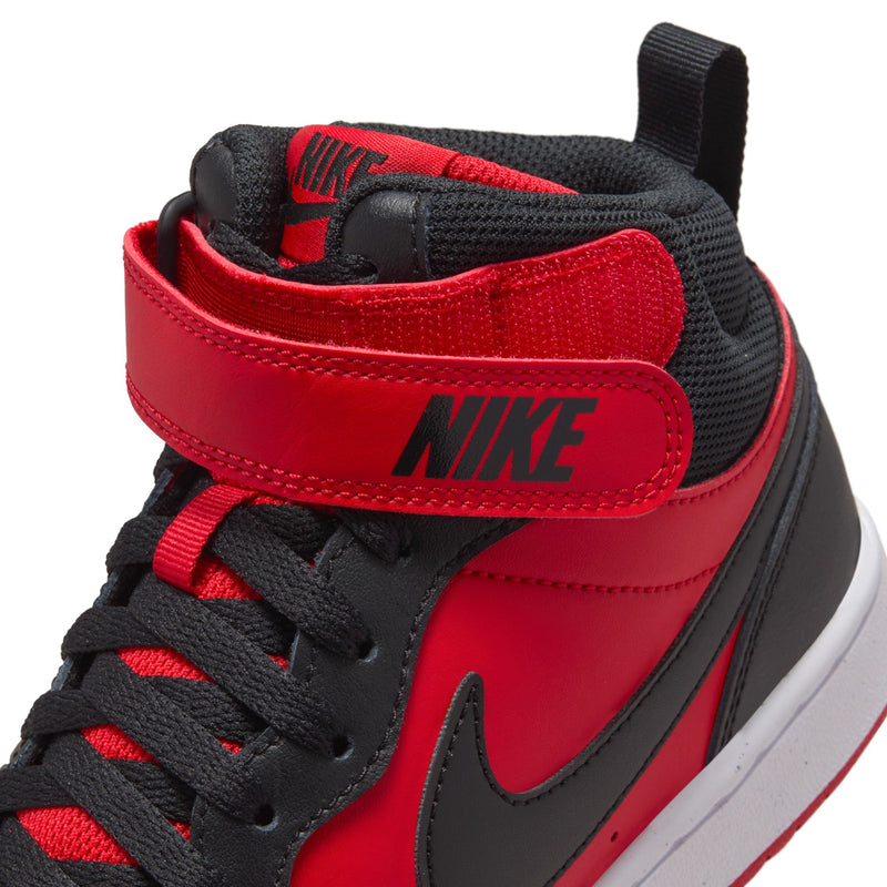 Close-up of youth Nike ankle strap and lace area, red with black Swoosh