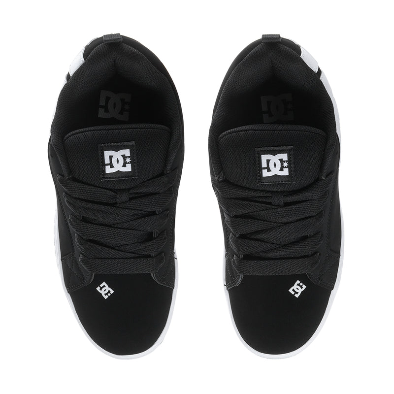 Black low-top sneakers with DC logo on heel tabs and black laces.
