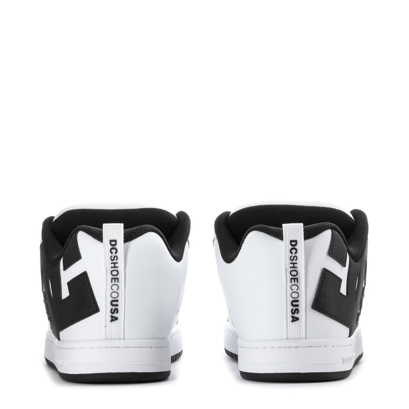 Men's white low-top sneakers with black heel panels and DC Shoes branding on back