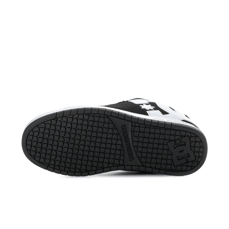Black rubber outsole with textured tread and DC-style star logo near toe.