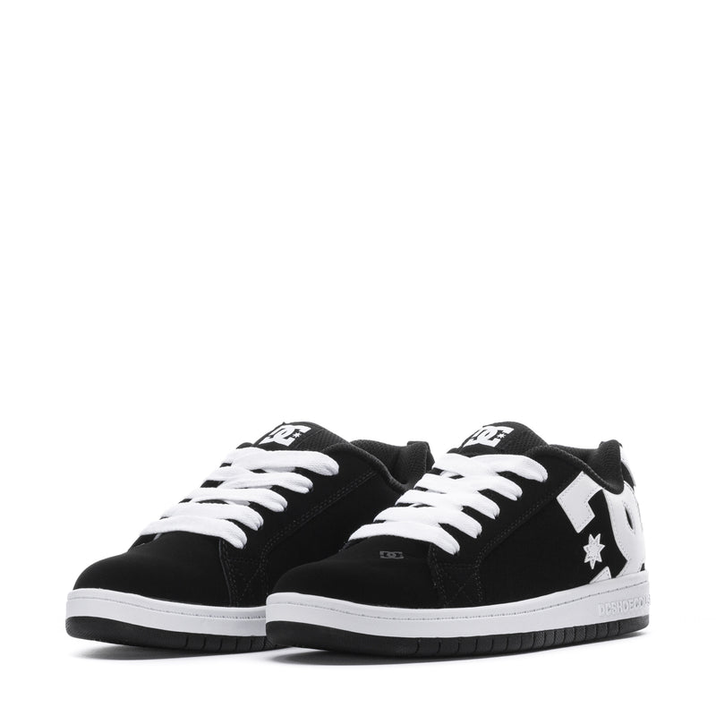 Youth black low-top sneakers with white laces, white tongue logo, and star detail