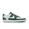 Green and white low-top lace-up sneakers with large white swoosh and perforated toe